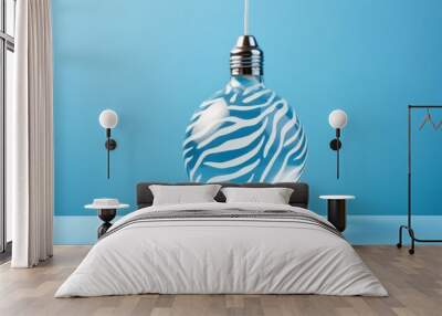 Christmas bulb decoration in zebra print against pastel blue background. New year creative concept Wall mural