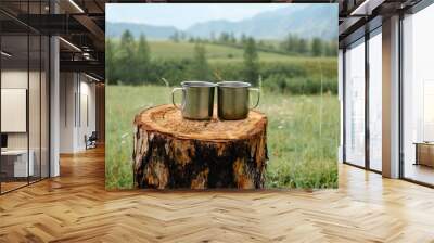 Two metal mugs on a wooden stump. Wall mural