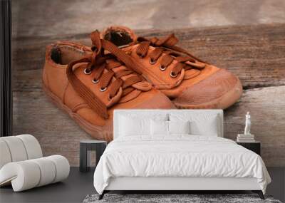 Old sneakers on wood background Wall mural