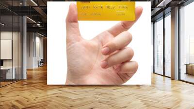 The woman's hand holds a gold credit card isolated on white background. Wall mural