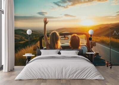 Back view of happy couple driving along country road in convertible car. Road trip, travel, holiday Wall mural