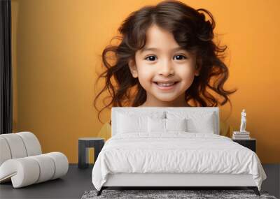 Portrait of happy smiling cute Asian girl against a yellow background. Studio shot, copy space Wall mural