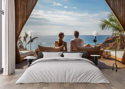 Rear view of couple relaxing on couch in luxury hotel. Summer, holiday, relax and lifestyle concept Wall mural