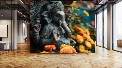 A beautifully carved statue of Lord Ganesha in a serene pose, adorned with vibrant flowers Wall mural