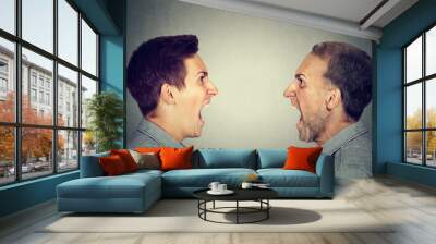 Angry young man screaming at old himself Wall mural