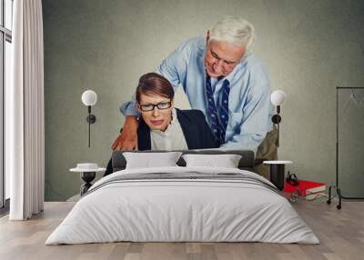 elderly businessman harassing his young colleague woman Wall mural