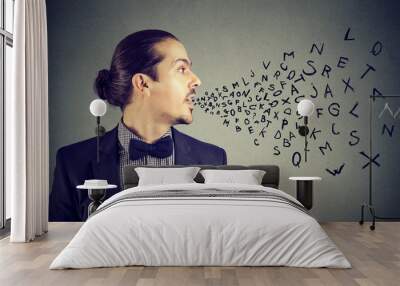 Man talking with alphabet letters coming out of his mouth. Communication, information, intelligence concept Wall mural