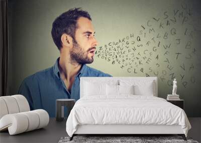 man talking with alphabet letters coming out of his mouth Wall mural