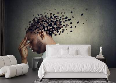 Side profile of a sad man losing parts of head as symbol of decreased mind function. Wall mural