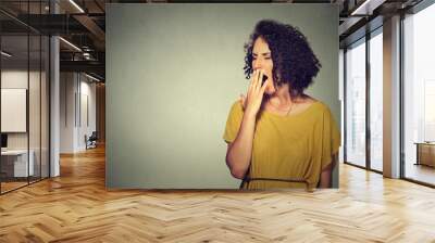 sleepy young woman with wide open mouth yawning eyes closed looking bored Wall mural