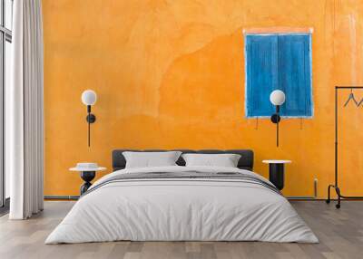 Abstract closed blue window on orange wall Wall mural