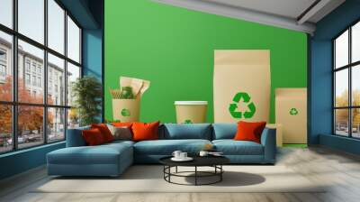 Eco-friendly packaging on a green background with recyclable symbols, perfect for promoting sustainability and environmental awareness. Wall mural