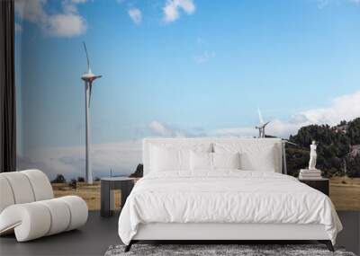 Natural view of windmills on vast dryland under a cloudy blue sky Wall mural