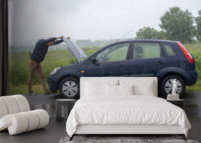 Car trouble. Engine failure in rain Wall mural