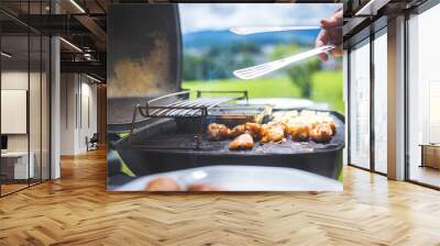 bbq on weekend. chicken wings, cheese and vegetables on gas grill. outdoors. Wall mural