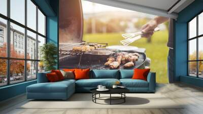 BBQ on weekend. Chicken wings, cheese and vegetables on gas grill. Outdoors. Wall mural