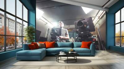 Cameraman operates a film camera, broadcasting recording studio Wall mural