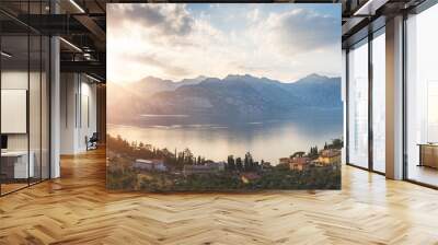 Idyllic coastline in Italy: Blue water and a cute village at lago di garda, Malcesine, sunset Wall mural