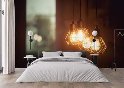 Lightning lamps at home, in restaurant or cafe: Close up of a hanging, orange lightbulbs Wall mural