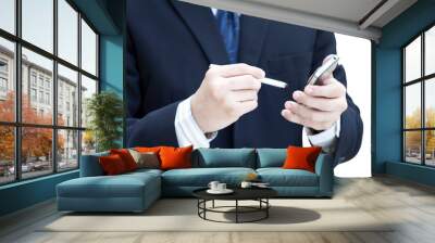 Business man using a mobile phone isolated on white Wall mural