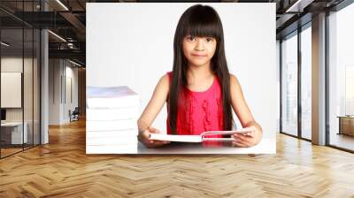 Little asian girl with books on the table Wall mural