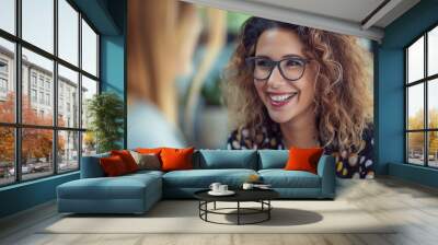 Happy mature professional business woman executive hr manager having job interview or business discussion with female applicant or colleague sitting at workplace in corporate office meeting. Wall mural