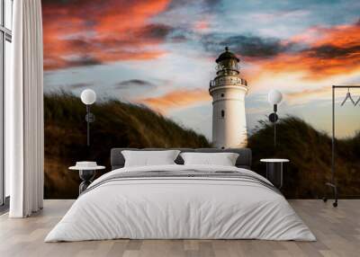 Beautiful shot of a lighthouse with the colorful skies in the background Wall mural