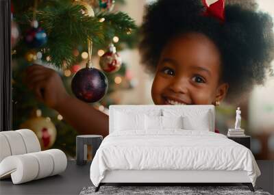 Smiling African American girl decorating Christmas tree, festive joy and holiday cheer at home. Child, ornament and celebration, happy family moment for seasonal tradition Wall mural