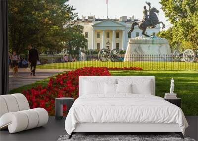 White House in Washington, D.C., United States. Color landscape photo in the early morning, a statue of Andrew Jackson in the foreground and red flowers leading up to statue with people on sidewalk Wall mural