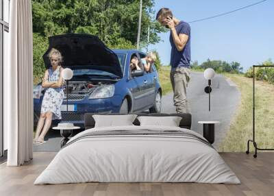 young family with car trouble on vacation. Man calling help services Wall mural