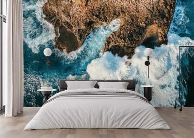 High angle aerial shot of rocks and huge waves on the seaside of Bali, Indonesia Wall mural