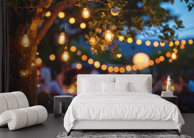 Close up of warm outdoor light bulbs with wedding reception blurred in background. Wall mural