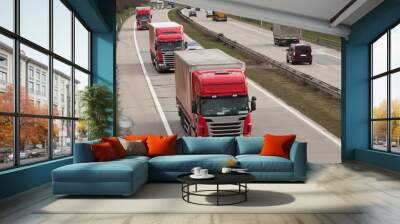 Red trucks driving on highway Wall mural