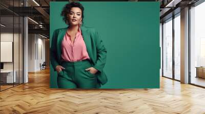 fashion shot of woman with chubby figure in a modern emerald green pant suit on a emerald green background. generative ai Wall mural