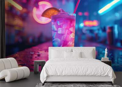 Closeup colorful frozen rave party drink glass with ice cubes on countertop in nightclub bar with orange, pink and blue neon lights background Wall mural