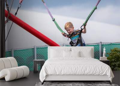 Little happy boy on a trampoline park Wall mural