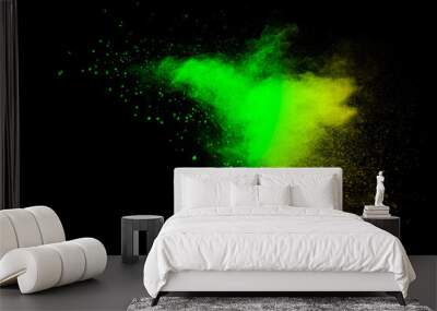 Abstract splash of green colored powder on black background.Green powder explosion. Wall mural