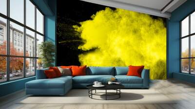 abstract yellow powder explosion on  black background.abstract yellow powder splatted on black background. Freeze motion of yellow powder exploding. Wall mural