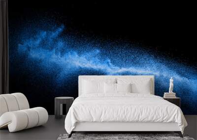 Blue color dust particles explosion cloud on black background.Color powder splash. Wall mural