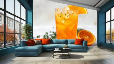 A glass of orange thyme spritz with an orange slice and thyme on a white background Wall mural