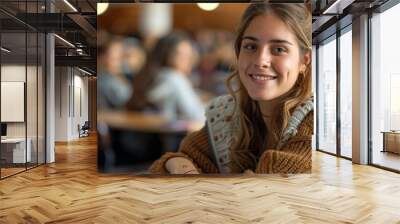 Confident female student smiling as she works on her laptop in a university setting, demonstrating academic ambition Wall mural