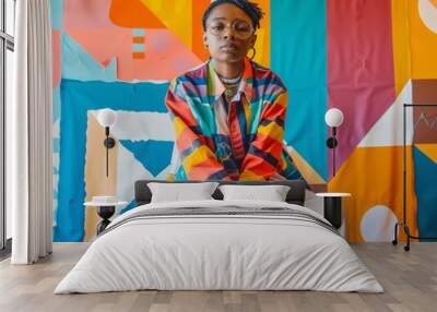 LGBTQ individual in a casual outfit, with a background of colorful geometric shapes, exuding positivity Wall mural