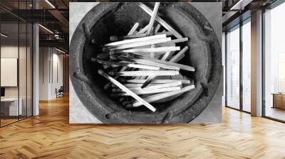 Burnt matches in an old saucer, black and white photo Wall mural