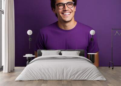 Handsome brunette man isolated on purple background Wall mural