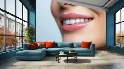 Woman with a pink lip is shown in a blue background. Concept of beauty and confidence, as the woman's lips are prominently displayed Wall mural