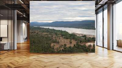 River with mountain reflection under cloudy sky Wall mural