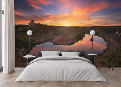 View of a colorful sunset from the Alarcon viewpoint, Cuenca, with the warm clouds reflecting in the Jucar River Wall mural