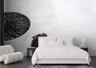 black caviar in bowl and on white shoop on marble  background Wall mural