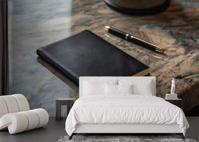 Black Leather Notebook with Pen on a Marble Table Wall mural