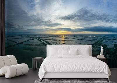 Aerial sunrise panorama view of colorful Mekong Delta over water and agricultural land in Vietnam. Wall mural